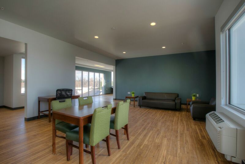 A common area at Redtail Ponds features a couch and a large table and seating area.