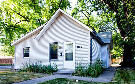 Front of the 817 Cherry Street home. The front door and two windows can be seen.
