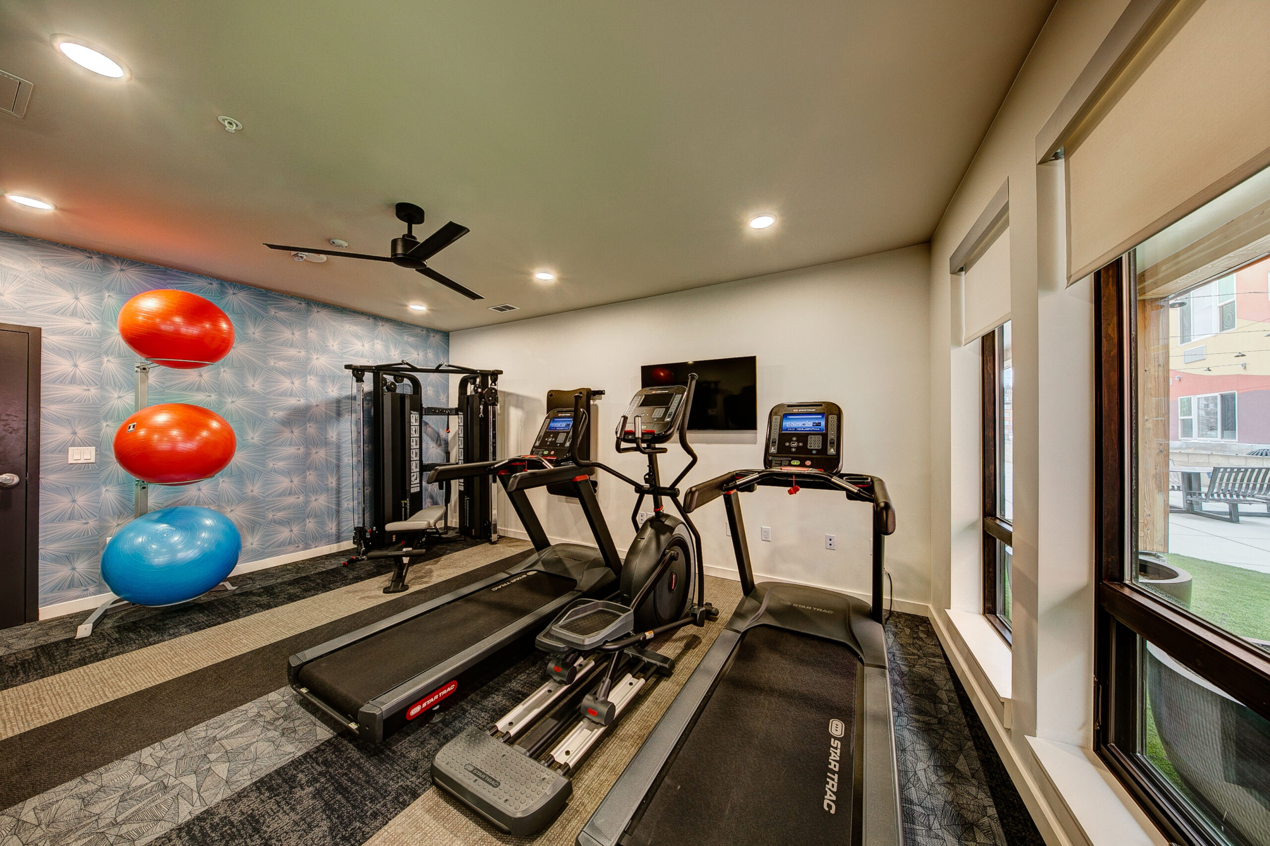 Fitness room with treadmills, weight, and exercise balls