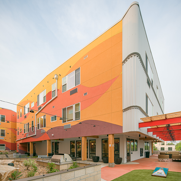 Outdoor terrace with colorfully patterned walls rising above