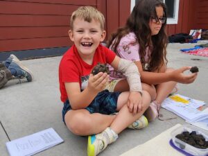 smiling boy holding a rock