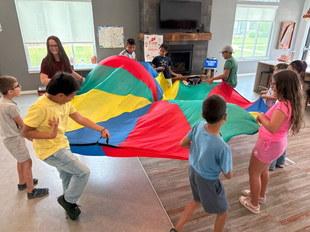 children playing with parachute