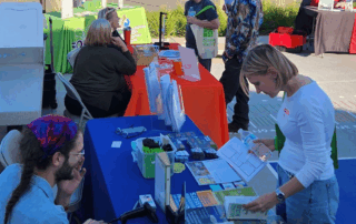 people visiting booth at fall financial fair