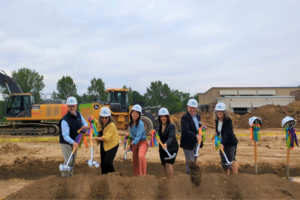 people posing at the village on eastbrook groundbreaking
